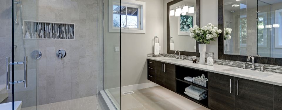 Bathroom with double sink countertop and walk-in shower.